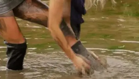 Leggy Blonde With Long Sexy Boots Is Walking In A Mud