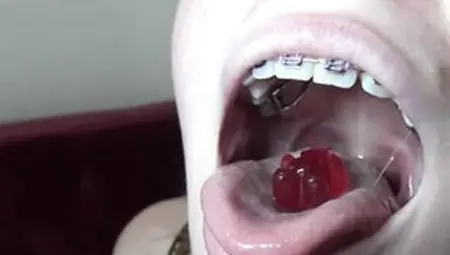 Blue- Eyed Golden-haired With Braces Is Licking And Eating Gummy Bears In A Very Hot Way