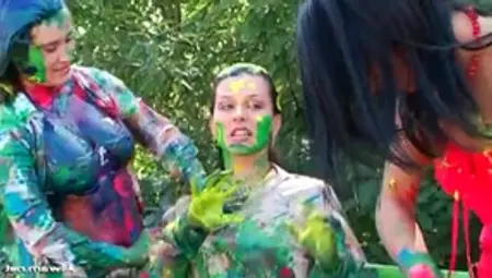 Girls Spread Body Paint On Each Other Outdoors