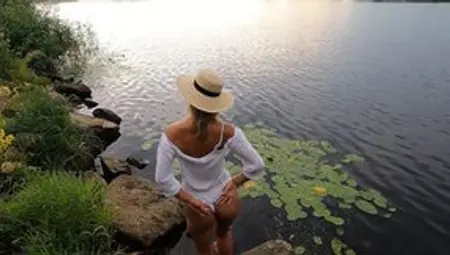Wonderful Blonde Woman Go Swim Inside Dress. Outdoors Nude.