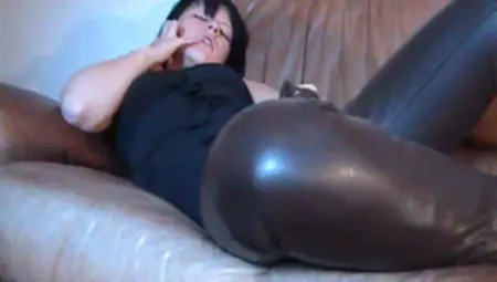 Horny Girl In Brown Leather Pants Masturbating On Leather Couch