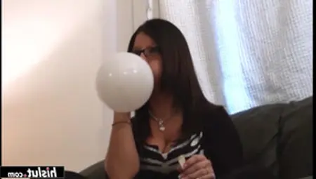 Two Girls Blowing Balloons Together
