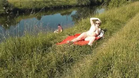 Naked Mature Woman Is Filmed While Sunbathing By The River