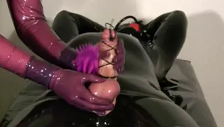 Dude In Latex Gets Massaged By His German Mistress